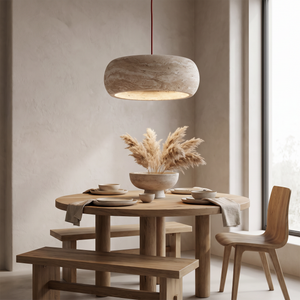 Rounded Kairi travertine pendant in a styled dining space