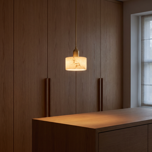 Lune Alabaster Pendant Light glowing with warm light in the evening